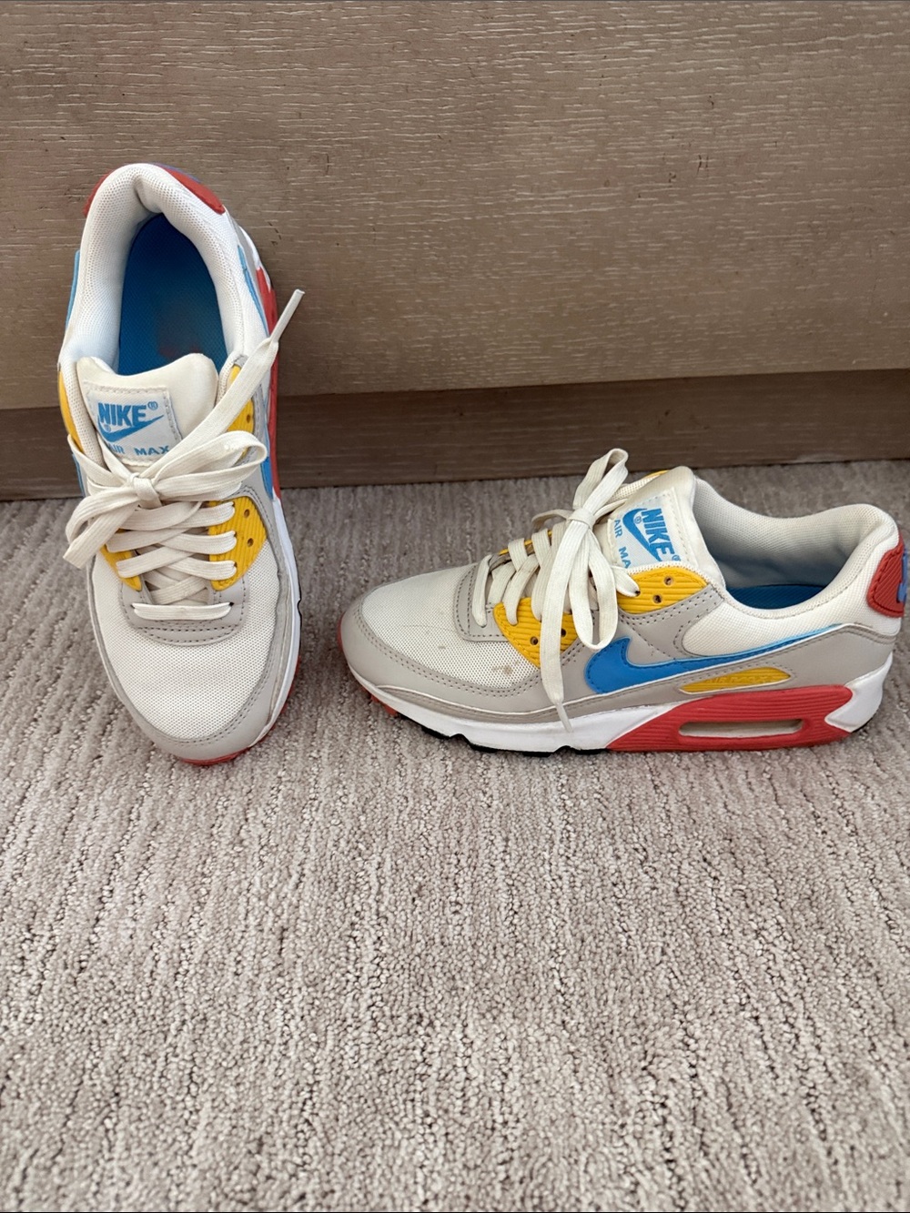 Nike White Sneakers with Blue Swoosh, Yellow Eyelets & Red Accents